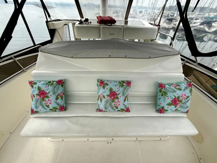  Yacht Photos Pics 1997 Silverton 402 Motor Yacht interior with floral cushions on white seating.