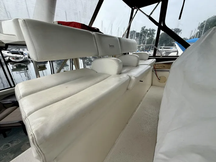  Yacht Photos Pics 1997 Silverton 402 Motor Yacht interior with white seating, docked at marina.