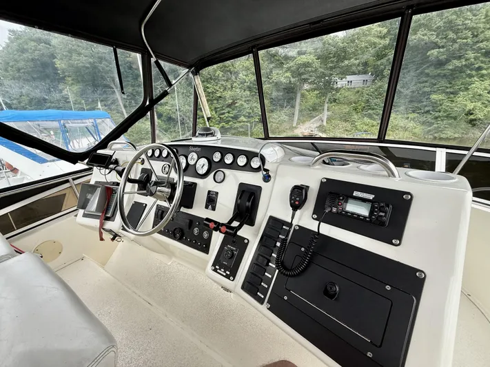  Yacht Photos Pics 1997 Silverton 402 Motor Yacht helm with steering wheel, gauges, and navigation equipment.