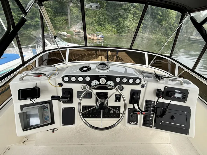  Yacht Photos Pics 1997 Silverton 402 Motor Yacht helm with steering wheel, gauges, and navigation equipment.