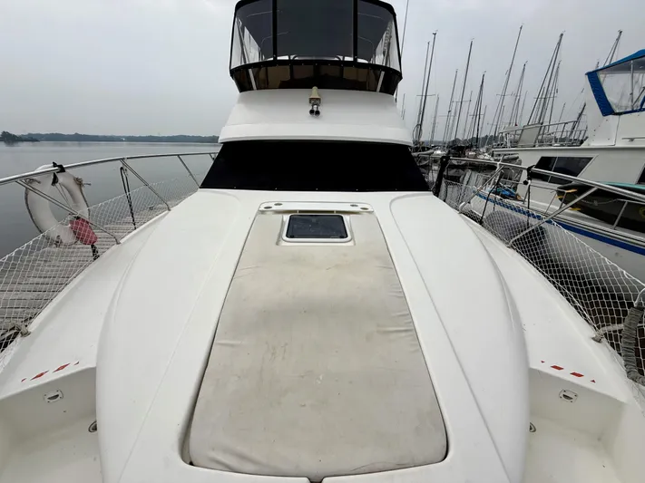  Yacht Photos Pics 1997 Silverton 402 Motor Yacht docked at marina, showcasing spacious deck and sleek design.