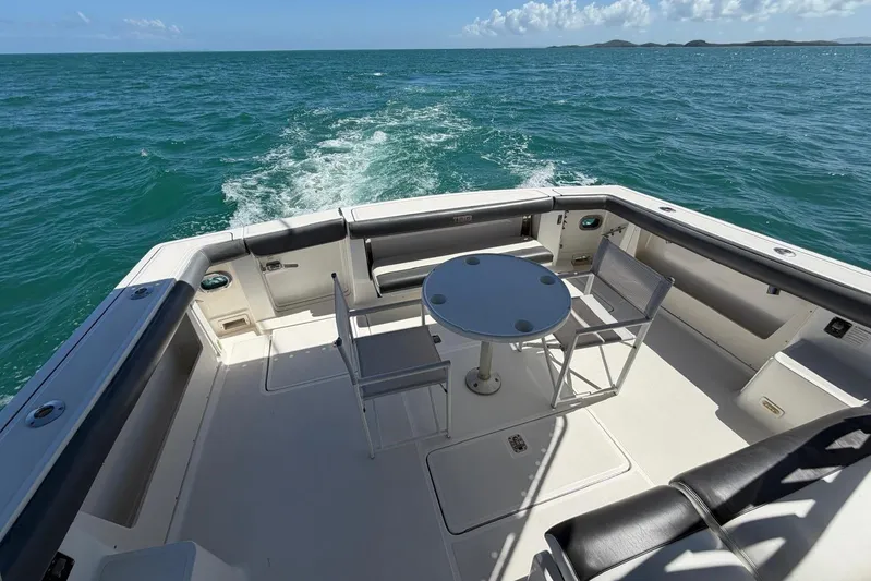  Yacht Photos Pics 1999 Tiara Yachts 4100 Open deck with seating and table, cruising on open water.