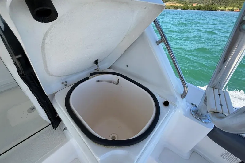  Yacht Photos Pics Open hatch on 1999 Tiara Yachts 4100 Open, revealing storage compartment by the sea.