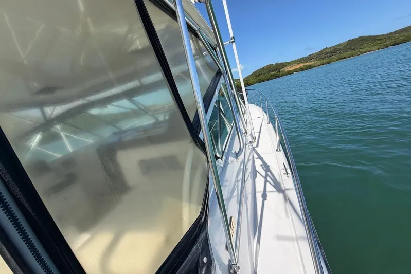  Yacht Photos Pics 1999 Tiara Yachts 4100 Open on calm waters, side view with clear skies.