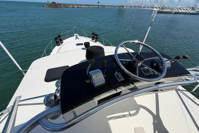  Yacht Photos Pics 1999 Tiara Yachts 4100 Open helm view, showcasing steering wheel and controls on open water.
