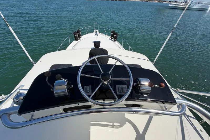  Yacht Photos Pics 1999 Tiara Yachts 4100 Open helm view, showcasing steering wheel and controls on open water.
