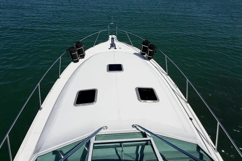  Yacht Photos Pics 1999 Tiara Yachts 4100 Open boat deck on calm water.