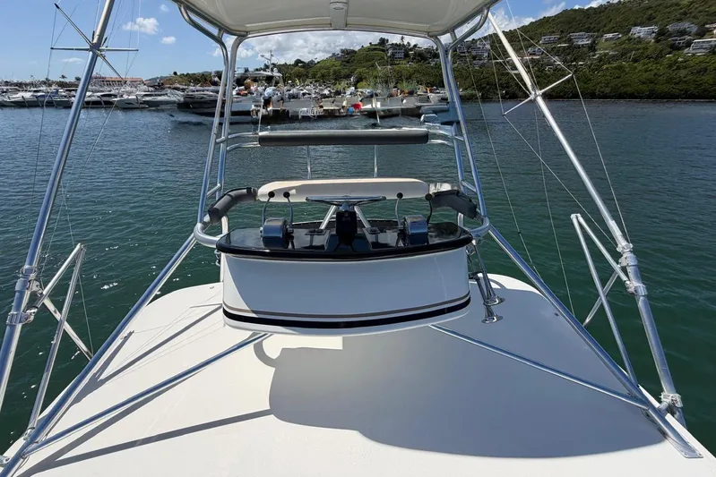  Yacht Photos Pics 1999 Tiara Yachts 4100 Open boat helm with marina and hillside view.