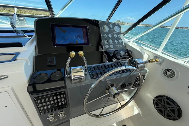  Yacht Photos Pics Cockpit of 1999 Tiara Yachts 4100 Open with navigation controls and steering wheel.