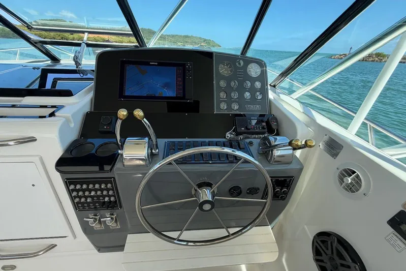  Yacht Photos Pics 1999 Tiara Yachts 4100 Open helm with navigation controls and ocean view.