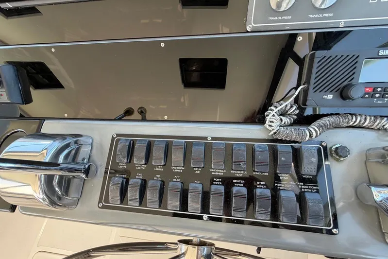  Yacht Photos Pics Control panel of a 1999 Tiara Yachts 4100 Open, featuring switches and navigation equipment.