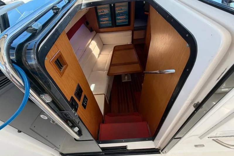  Yacht Photos Pics Interior view of 1999 Tiara Yachts 4100 Open, featuring cozy seating and wooden accents.