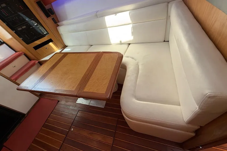  Yacht Photos Pics 1999 Tiara Yachts 4100 Open interior with white seating and wooden table.