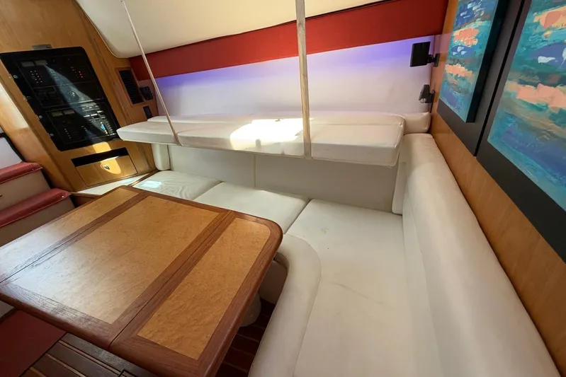  Yacht Photos Pics Interior of 1999 Tiara Yachts 4100 Open with white seating and wooden table.