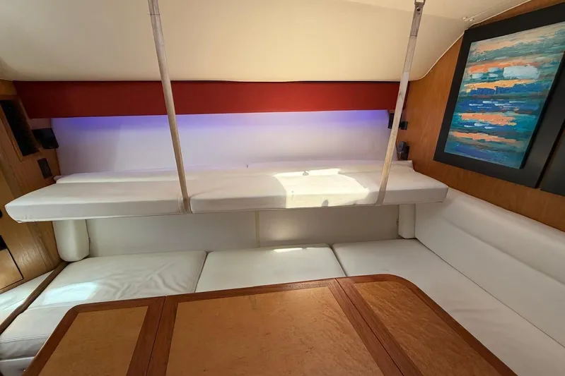  Yacht Photos Pics Interior of 1999 Tiara Yachts 4100 Open with white seating and colorful artwork.