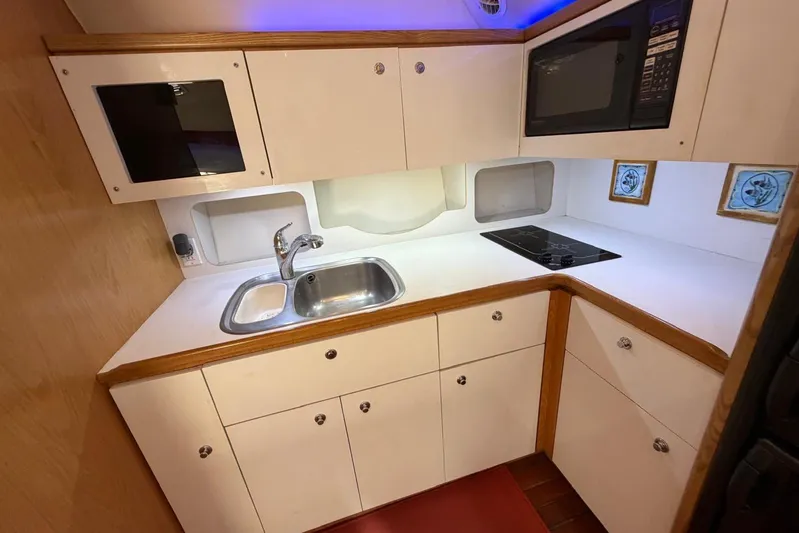  Yacht Photos Pics 1999 Tiara Yachts 4100 Open galley with sink, stove, and microwave.