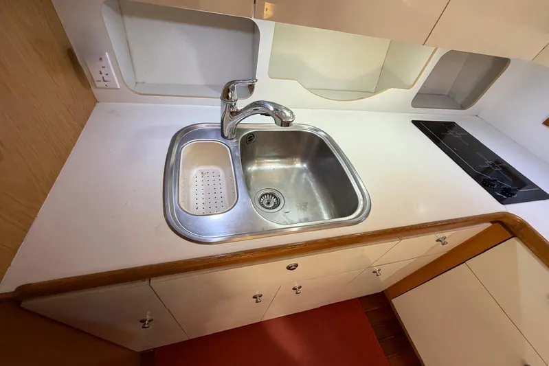  Yacht Photos Pics 1999 Tiara Yachts 4100 Open kitchen with stainless steel sink and electric stove.