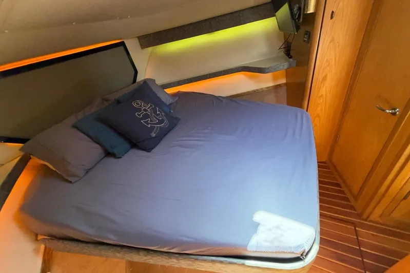  Yacht Photos Pics Luxurious cabin interior of 1999 Tiara Yachts 4100 Open with cozy bedding.