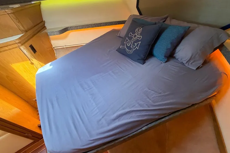  Yacht Photos Pics Cozy bedroom in 1999 Tiara Yachts 4100 Open with nautical-themed pillow.