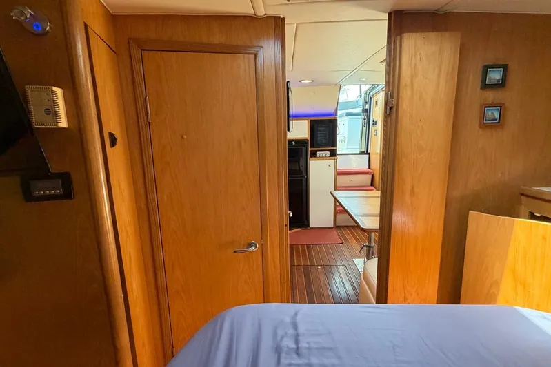  Yacht Photos Pics Interior of 1999 Tiara Yachts 4100 Open, featuring wood paneling and cozy seating area.