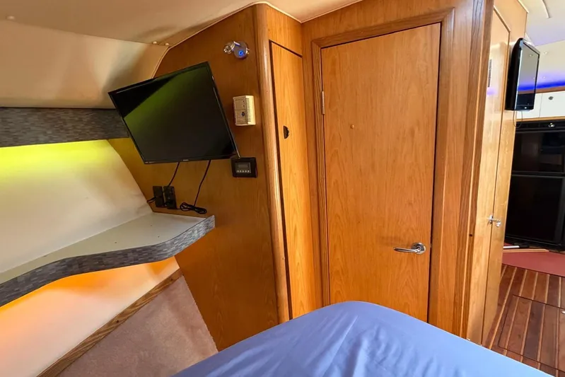  Yacht Photos Pics Interior of 1999 Tiara Yachts 4100 Open with wood paneling and mounted TV.