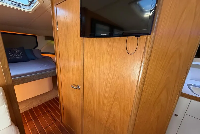  Yacht Photos Pics Interior of 1999 Tiara Yachts 4100 Open, featuring a cozy cabin with wood paneling.