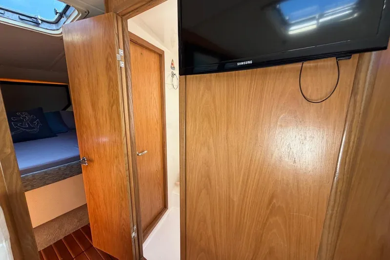  Yacht Photos Pics Interior of 1999 Tiara Yachts 4100 Open with wood paneling and a mounted TV.