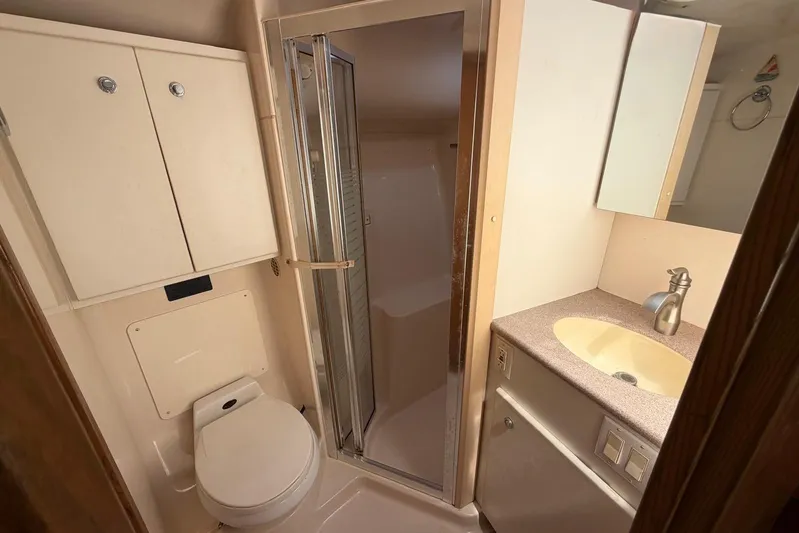  Yacht Photos Pics Bathroom interior of 1999 Tiara Yachts 4100 Open with shower, sink, and toilet.