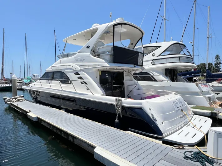 Bella Jolie Yacht Photos Pics 2002 Sea Ray 560 Sedan Bridge yacht docked at marina under clear blue sky.