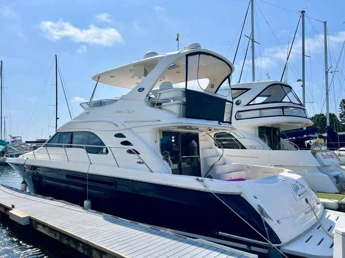 Bella Jolie Yacht Photos Pics 2002 Sea Ray 560 Sedan Bridge yacht docked at marina under clear blue sky.