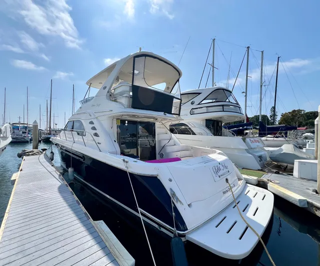 Bella Jolie Yacht Photos Pics 2002 Sea Ray 560 Sedan Bridge yacht docked at marina under clear blue sky.