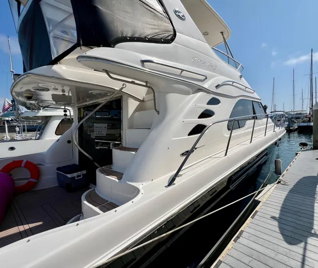 Bella Jolie Yacht Photos Pics 2002 Sea Ray 560 Sedan Bridge yacht docked at marina, side view.
