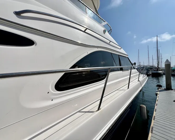 Bella Jolie Yacht Photos Pics 2002 Sea Ray 560 Sedan Bridge yacht docked at marina, side view.