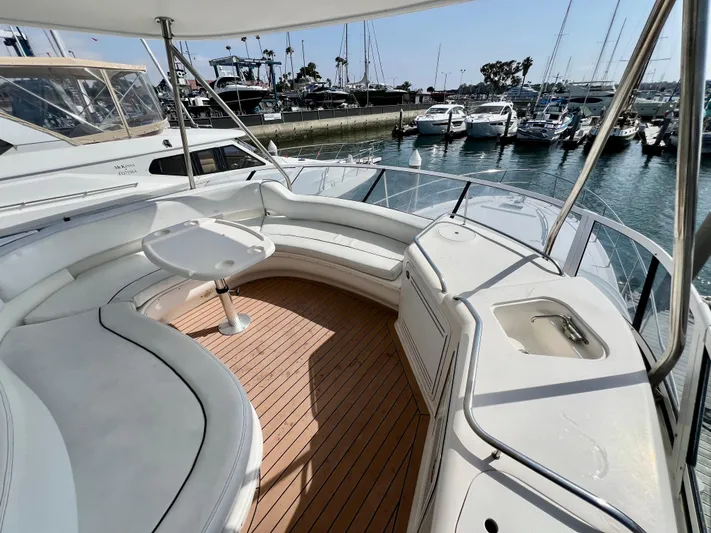 Bella Jolie Yacht Photos Pics 2002 Sea Ray 560 Sedan Bridge yacht with spacious deck and marina view.