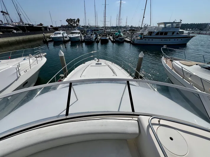 Bella Jolie Yacht Photos Pics 2002 Sea Ray 560 Sedan Bridge yacht docked in a marina, surrounded by other boats.