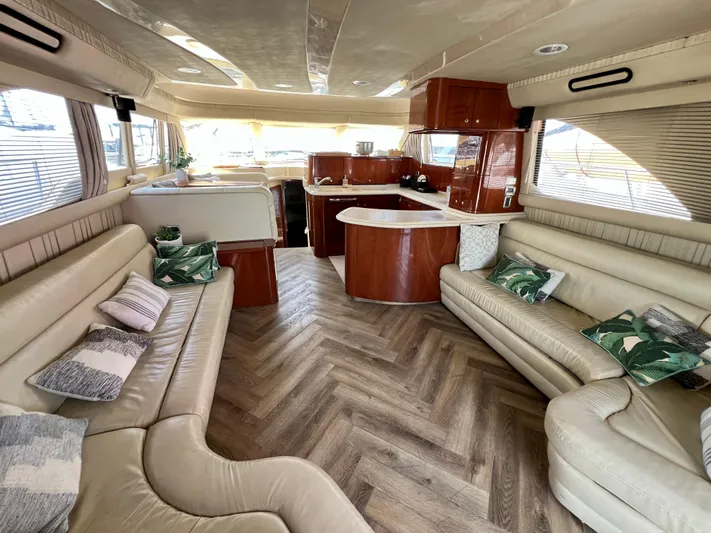 Bella Jolie Yacht Photos Pics Luxurious interior of a 2002 Sea Ray 560 Sedan Bridge yacht with elegant seating and wood finishes.