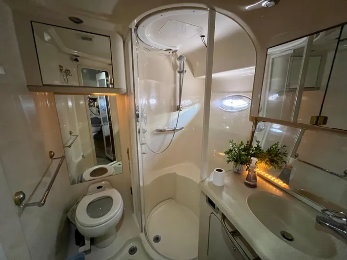 Bella Jolie Yacht Photos Pics Luxurious bathroom in 2002 Sea Ray 560 Sedan Bridge yacht with shower, sink, and toilet.