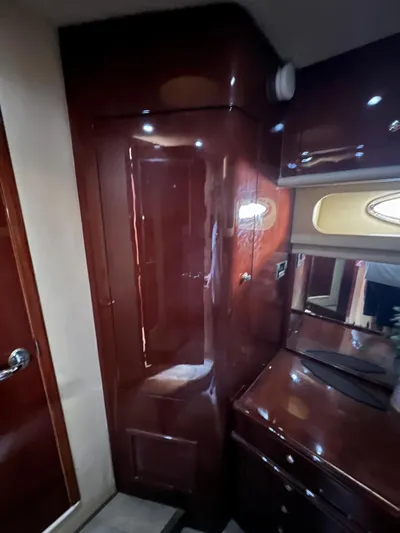 Bella Jolie Yacht Photos Pics Interior of 2002 Sea Ray 560 Sedan Bridge with glossy wood finish and cabinetry.