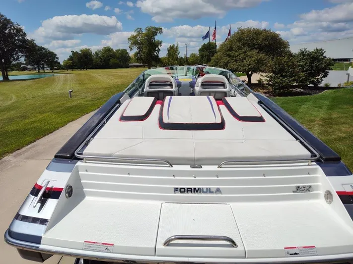  Yacht Photos Pics 2015 Formula 382 FASTech boat, rear view, parked on a sunny day with lush greenery.