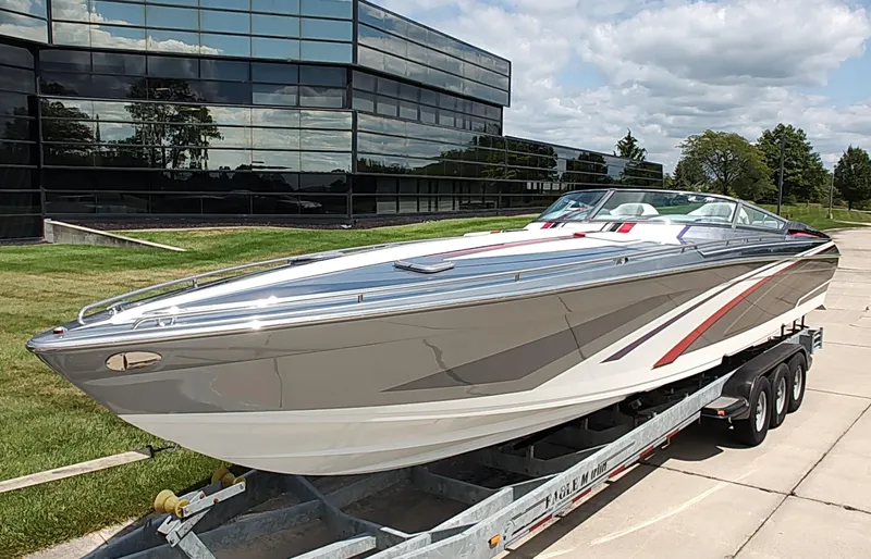  Yacht Photos Pics 2015 Formula 382 FASTech boat on trailer, sleek design, parked near modern glass building.