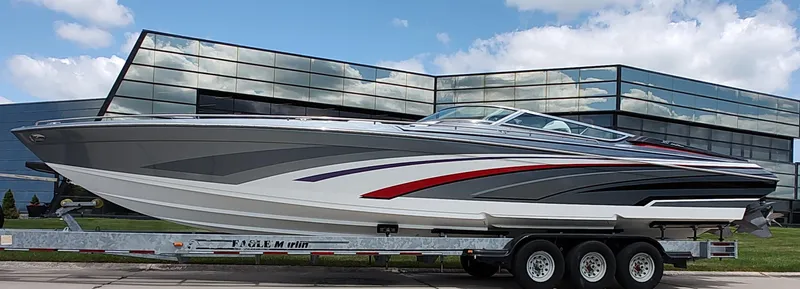  Yacht Photos Pics 2015 Formula 382 FASTech boat on trailer, sleek design, parked near modern glass building.