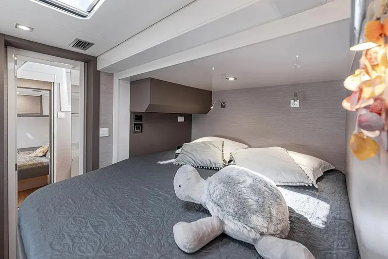  Yacht Photos Pics Luxurious bedroom in 2026 Aventura 56 MY yacht with plush bedding and soft lighting.