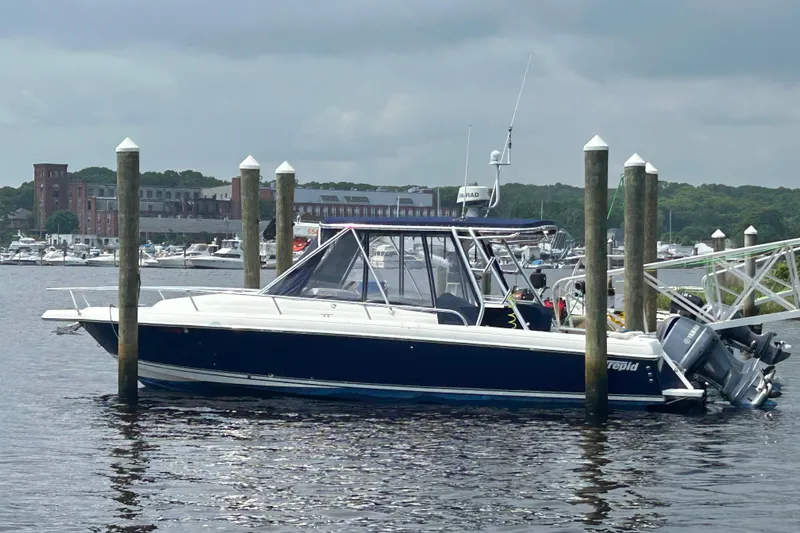  Yacht Photos Pics 2003 Intrepid 310 Walkaround boat docked in a marina with overcast skies.