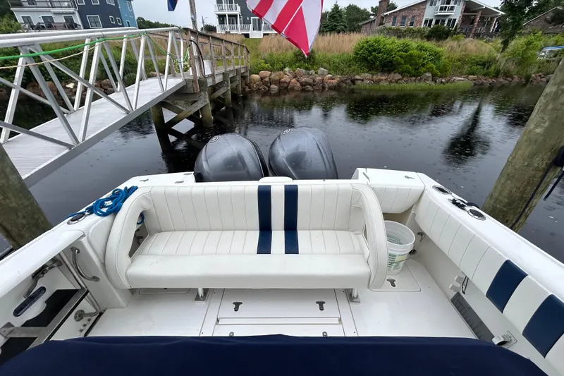  Yacht Photos Pics 2003 Intrepid 310 Walkaround boat docked, featuring dual engines and white seating with blue accents.