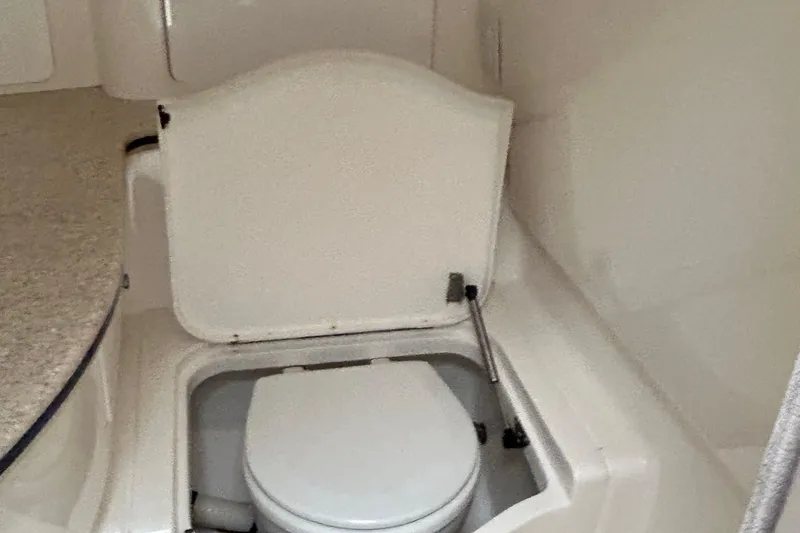  Yacht Photos Pics 2003 Intrepid 310 Walkaround boat interior with compact marine toilet.