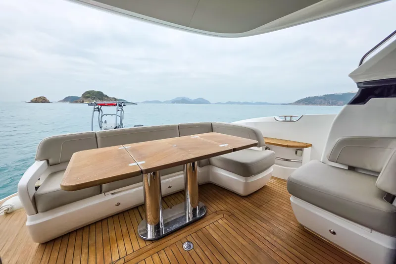  Yacht Photos Pics Luxurious 2019 Princess F45 yacht deck with seating and table, overlooking serene ocean view.