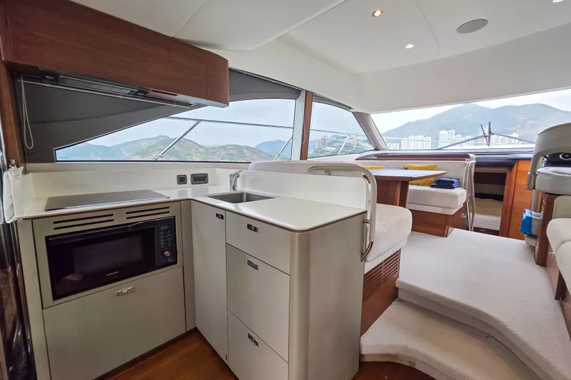  Yacht Photos Pics Interior of 2019 Princess F45 yacht with modern kitchen and seating area.