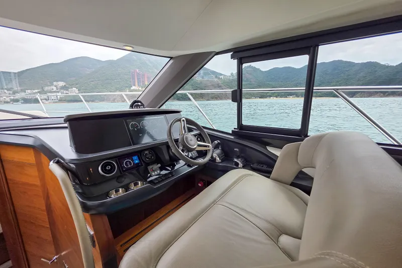 Yacht Photos Pics Interior view of 2019 Princess F45 yacht helm with scenic ocean backdrop.