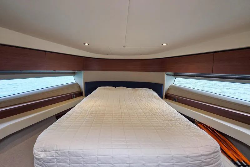  Yacht Photos Pics Luxurious cabin interior of 2019 Princess F45 yacht with elegant bedding and wood accents.