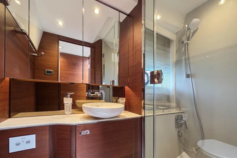  Yacht Photos Pics Luxurious bathroom in 2019 Princess F45 yacht with modern fixtures and wooden accents.